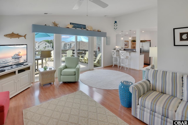 1143 Albemarle Ct Unit 681, Corolla, NC 27927 - living area featuring a ceiling fan, vaulted ceiling, and light wood-style floors