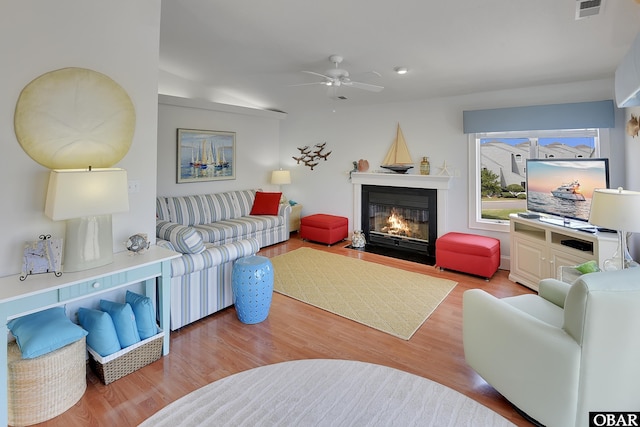 1143 Albemarle Ct Unit 681, Corolla, NC 27927 - living room with a ceiling fan, a fireplace with flush hearth, and wood finished floors