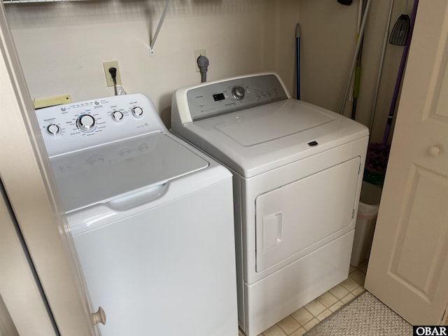 1143 Albemarle Ct Unit 681, Corolla, NC 27927 - washroom featuring washing machine and clothes dryer and light tile patterned flooring