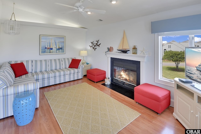 1143 Albemarle Ct Unit 681, Corolla, NC 27927 - living room featuring a ceiling fan, a fireplace with flush hearth, light wood-style flooring, and vaulted ceiling