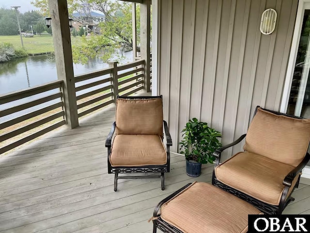 wooden deck featuring a water view