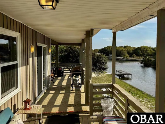 wooden terrace featuring a water view