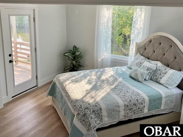bedroom featuring baseboards and light wood-style flooring