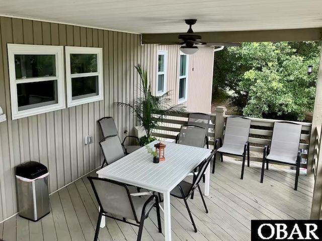 wooden deck featuring a ceiling fan and outdoor dining space