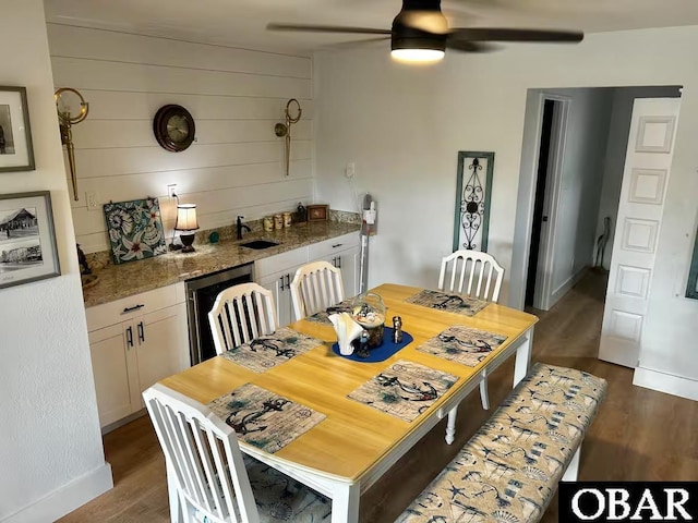 dining room with baseboards, dark wood finished floors, and ceiling fan