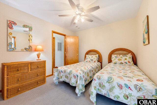 carpeted bedroom featuring a ceiling fan and visible vents