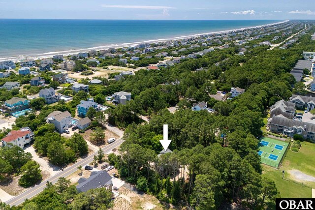 bird's eye view featuring a beach view, a water view, and a residential view