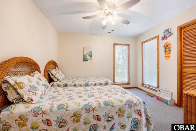 bedroom featuring carpet floors, visible vents, a ceiling fan, baseboards, and a closet