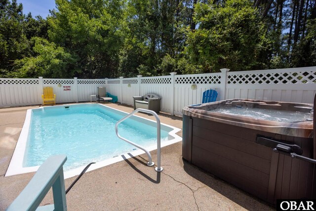 view of pool with fence private yard, a fenced in pool, and a hot tub