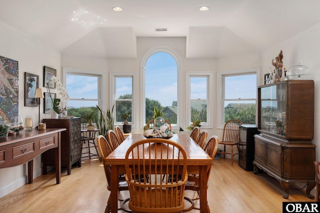 dining space with a healthy amount of sunlight, light wood-style flooring, and visible vents