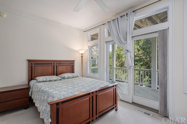 bedroom featuring access to exterior, visible vents, light carpet, and a ceiling fan