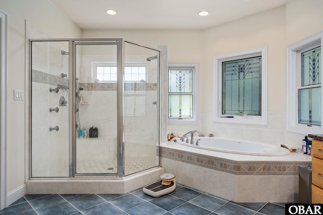 bathroom featuring a stall shower, recessed lighting, a garden tub, and tile patterned floors