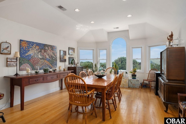 dining space with light wood-style floors, recessed lighting, visible vents, and lofted ceiling