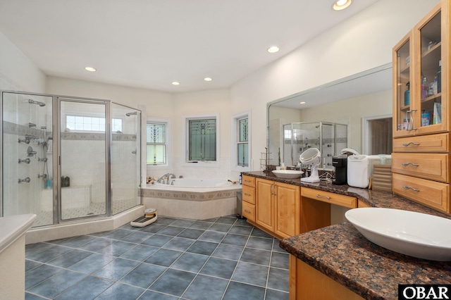 bathroom with a garden tub, tile patterned flooring, a stall shower, and vanity