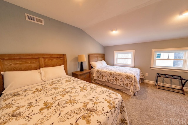 bedroom with lofted ceiling, baseboards, visible vents, and carpet