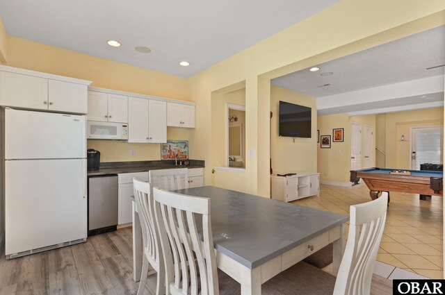 kitchen featuring recessed lighting, white appliances, billiards, white cabinetry, and dark countertops