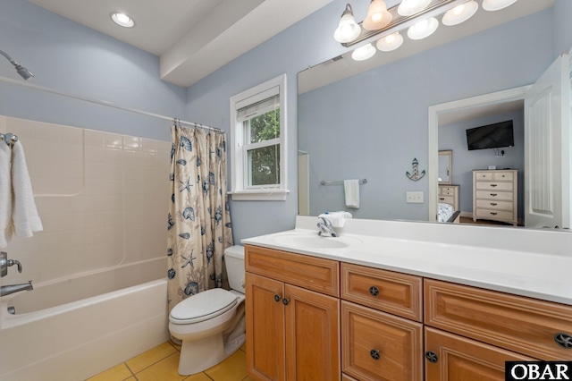 ensuite bathroom with shower / bath combination with curtain, toilet, ensuite bathroom, vanity, and tile patterned flooring