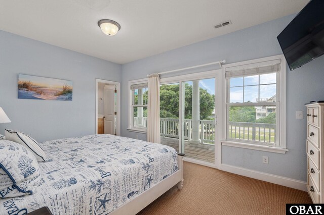 bedroom with access to outside, visible vents, light carpet, and baseboards