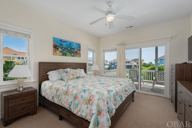 bedroom featuring light carpet, access to exterior, visible vents, and a ceiling fan