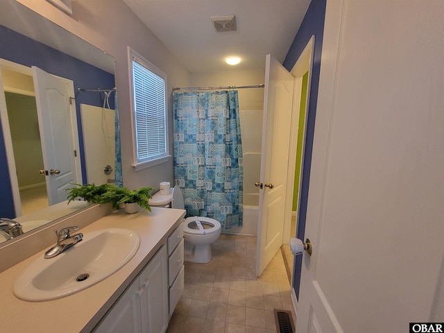 bathroom with vanity, toilet, visible vents, and tile patterned floors