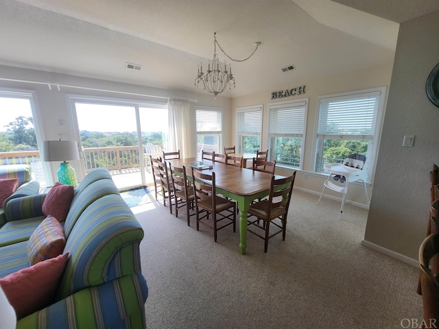 dining room featuring light colored carpet, visible vents, baseboards, and an inviting chandelier