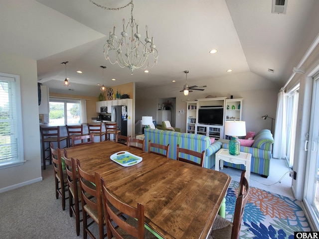 dining room featuring ceiling fan with notable chandelier, visible vents, light colored carpet, vaulted ceiling, and recessed lighting
