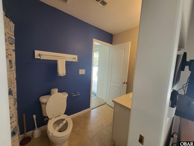 bathroom featuring toilet, visible vents, baseboards, and vanity