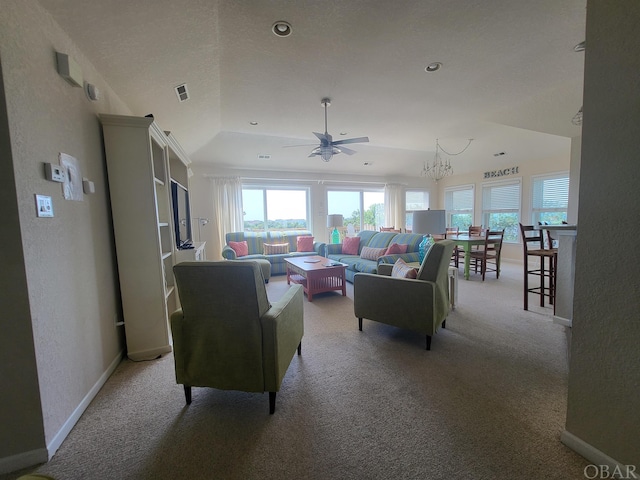 living area featuring a raised ceiling, light colored carpet, a textured wall, visible vents, and baseboards