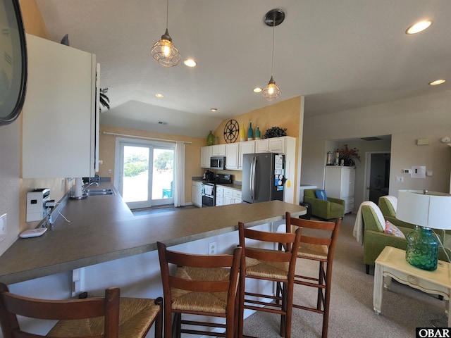 kitchen with white cabinetry, recessed lighting, a peninsula, and appliances with stainless steel finishes