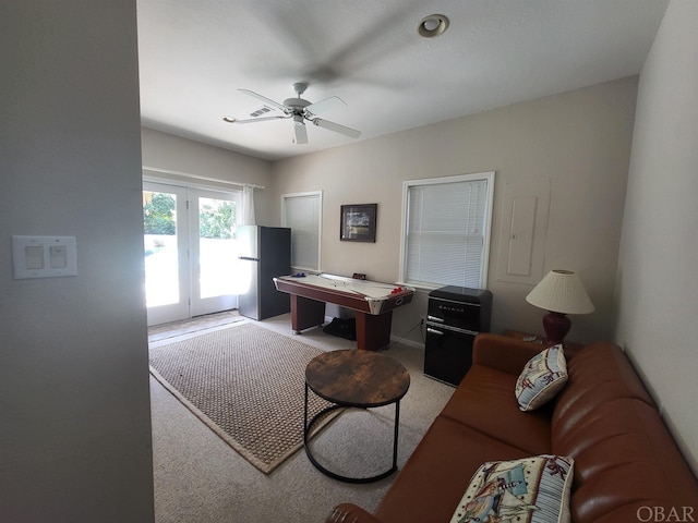 living room featuring a ceiling fan and light carpet