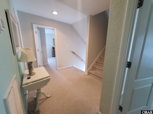 hallway featuring recessed lighting, an upstairs landing, and carpet floors