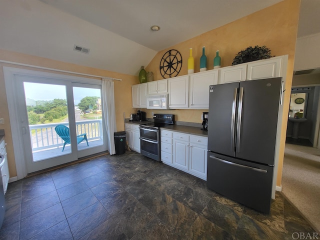 kitchen with visible vents, vaulted ceiling, appliances with stainless steel finishes, and white cabinets