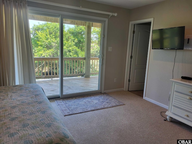 doorway to outside featuring baseboards and carpet floors