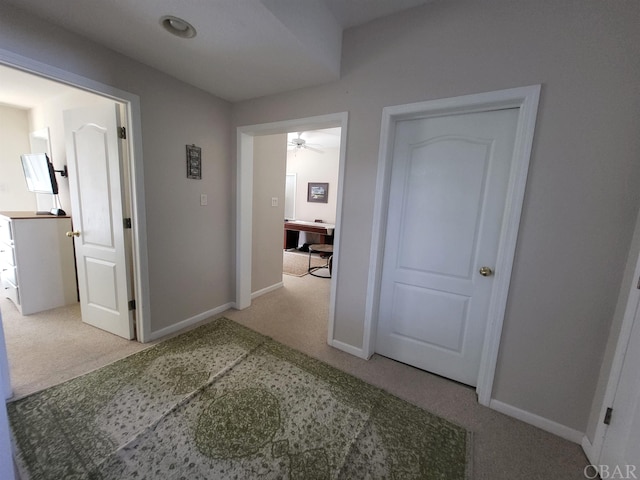 hall with carpet and baseboards