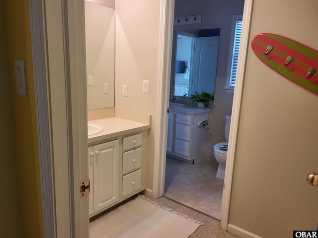 bathroom featuring tile patterned floors, toilet, and vanity