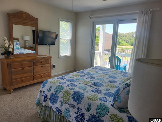 bedroom with carpet, access to outside, and baseboards