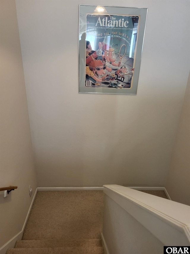stairway featuring carpet and baseboards