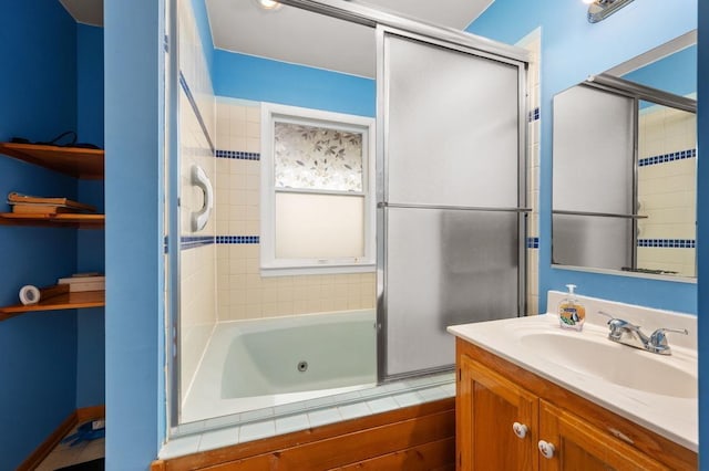 bathroom with a combined bath / shower with jetted tub and vanity