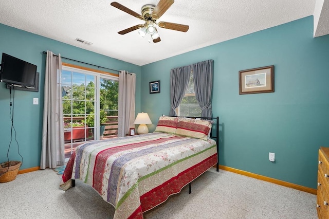 bedroom featuring a textured ceiling, carpet floors, visible vents, and baseboards