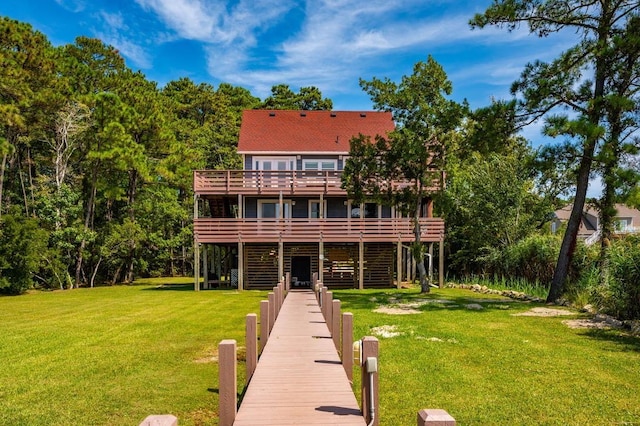 back of property featuring a lawn