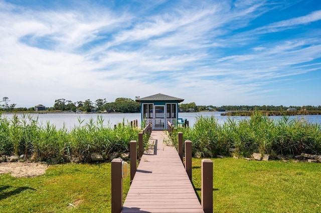 dock area with a water view and a lawn