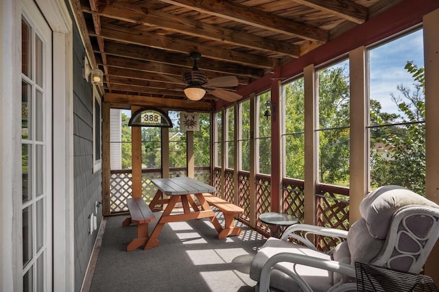 unfurnished sunroom featuring plenty of natural light and a ceiling fan