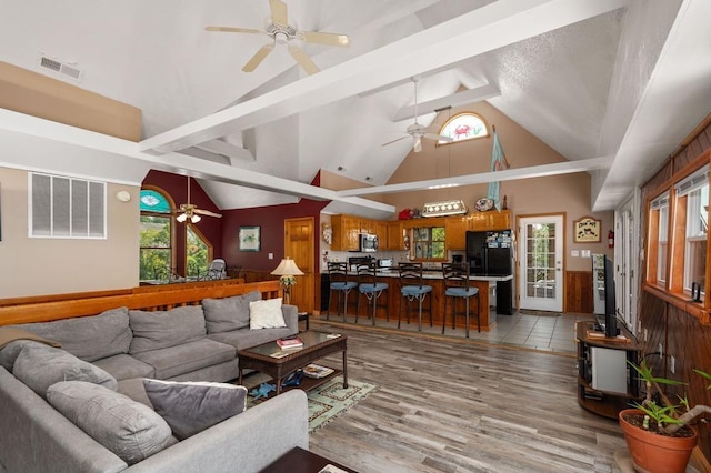 living area featuring a ceiling fan, light wood-type flooring, and visible vents