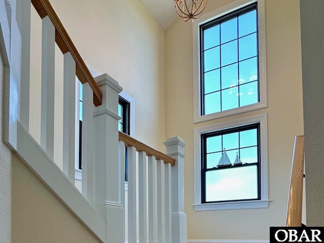 126 Buffell Head Rd Lot 146, Duck, NC 27949 - entryway with healthy amount of natural light, stairway, high vaulted ceiling, and a chandelier