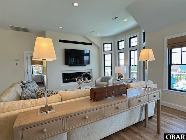 126 Buffell Head Rd Lot 146, Duck, NC 27949 - living room with a warm lit fireplace, wood finished floors, recessed lighting, and baseboards