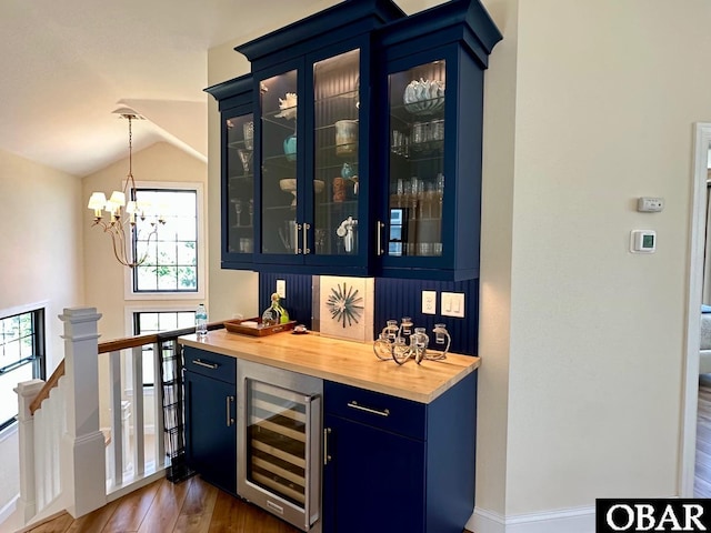 126 Buffell Head Rd Lot 146, Duck, NC 27949 - indoor dry bar with beverage cooler, dark wood-style floors, a chandelier, decorative light fixtures, and lofted ceiling