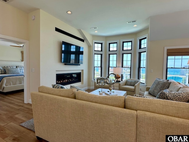 126 Buffell Head Rd Lot 146, Duck, NC 27949 - living area featuring baseboards, wood finished floors, plenty of natural light, a glass covered fireplace, and recessed lighting
