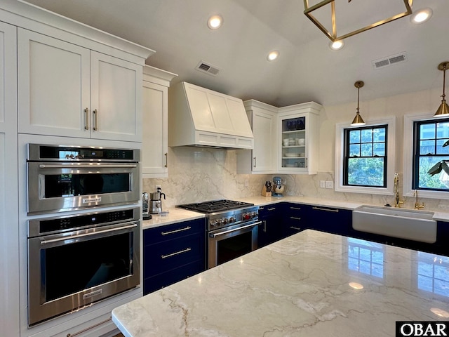 126 Buffell Head Rd Lot 146, Duck, NC 27949 - kitchen with stainless steel appliances, premium range hood, a sink, decorative backsplash, and white cabinetry