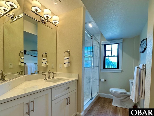 126 Buffell Head Rd Lot 146, Duck, NC 27949 - bathroom with toilet, a shower stall, a textured ceiling, wood finished floors, and vanity
