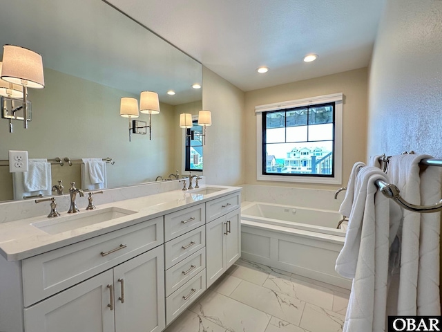 126 Buffell Head Rd Lot 146, Duck, NC 27949 - bathroom featuring marble look tiles, a bath, double vanity, and recessed lighting